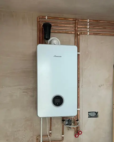 New Worcester combi boiler with copper pipework in a newly plastered extension